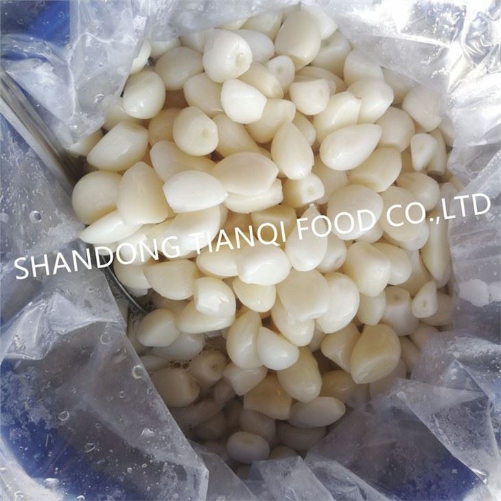 New crop peeled white garlic in brine in drums